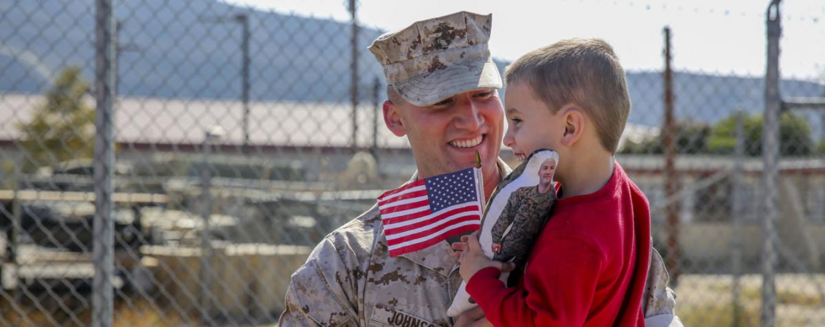 Marine holding child