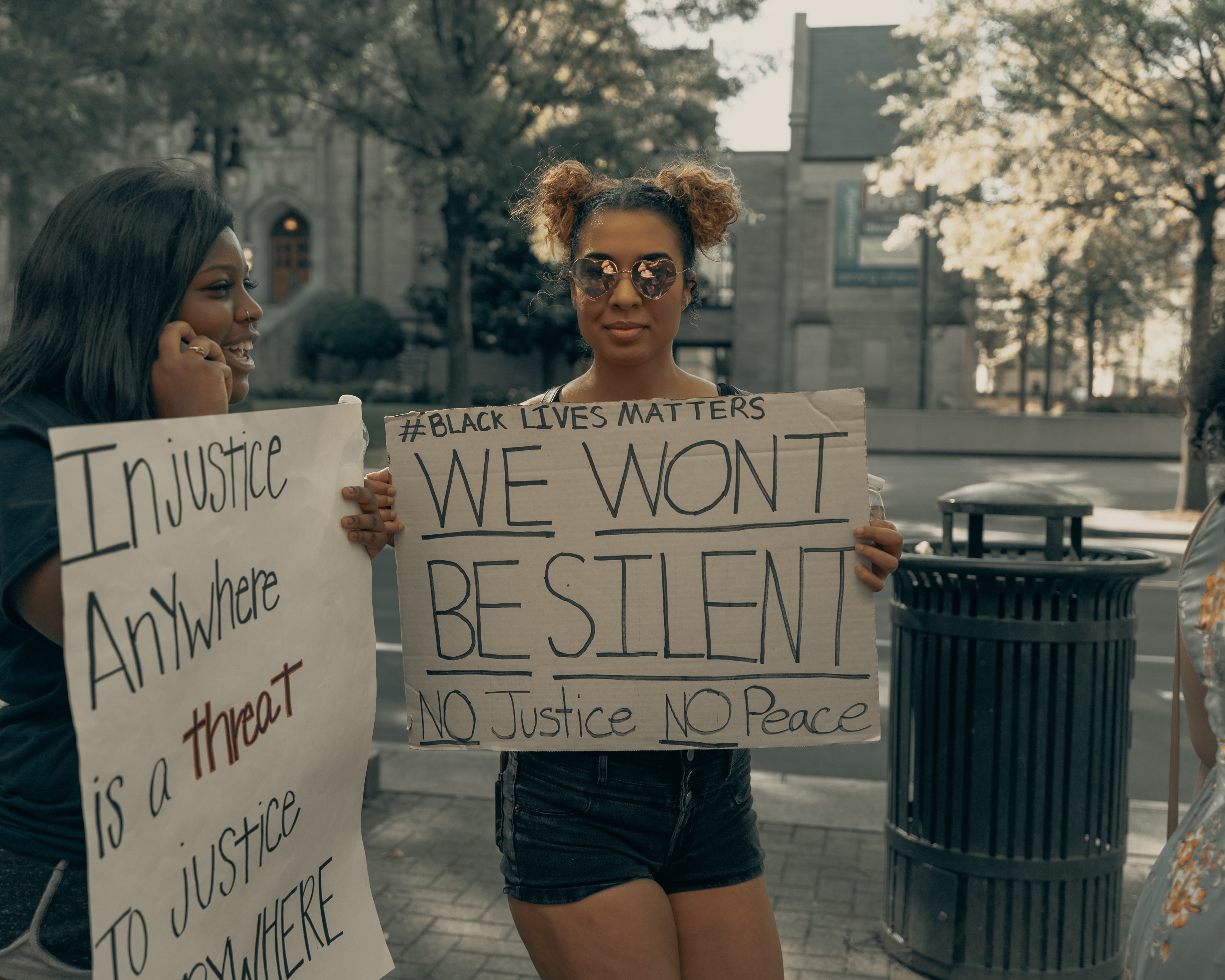 Two females holding posters during a black activist rally. 