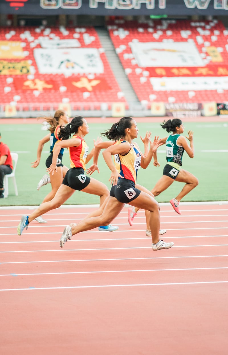 Four females running in a race. 