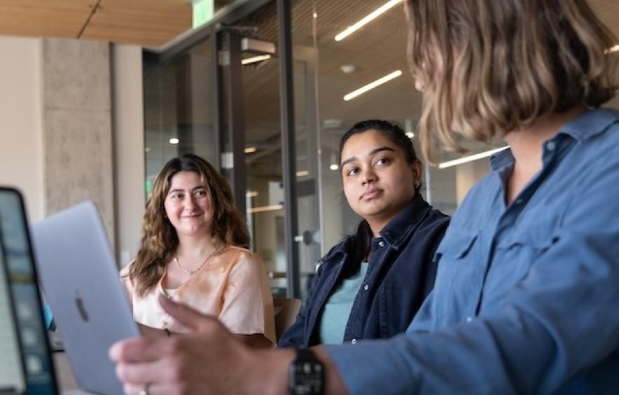 three women working at a conference table