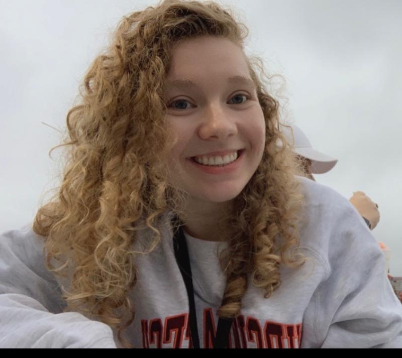 Young woman smiles for photo