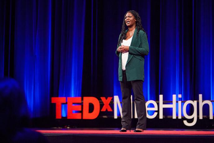 Dr. Apryl Alexander giving a Ted Talk presentation