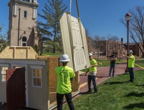 Students construct a playhouse in April 2016