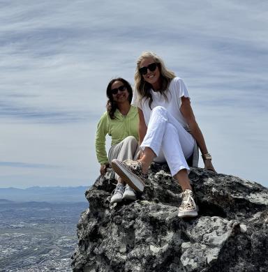Professors Lavita Nadkarni and Kim Gorgens sit atop Table Mountain in Cape Town, South Africa.